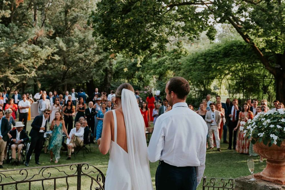 The newlyweds facing their guests during the ceremony