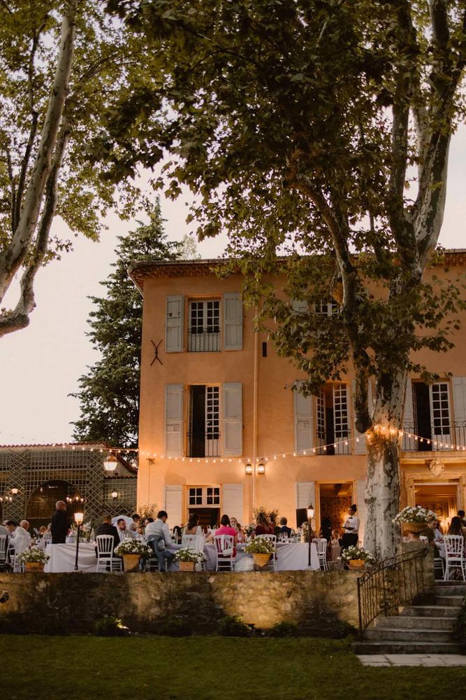 The façade lit up at dusk