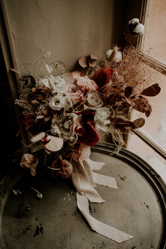 The bouquet on a side table by the window