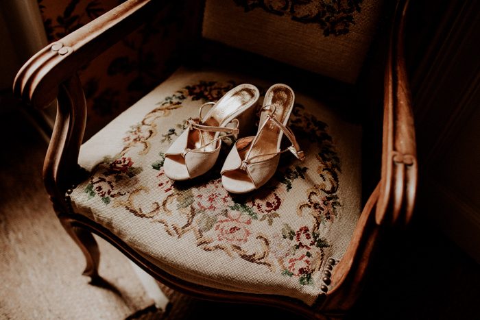 The bride's shoes on an embroidered armchair