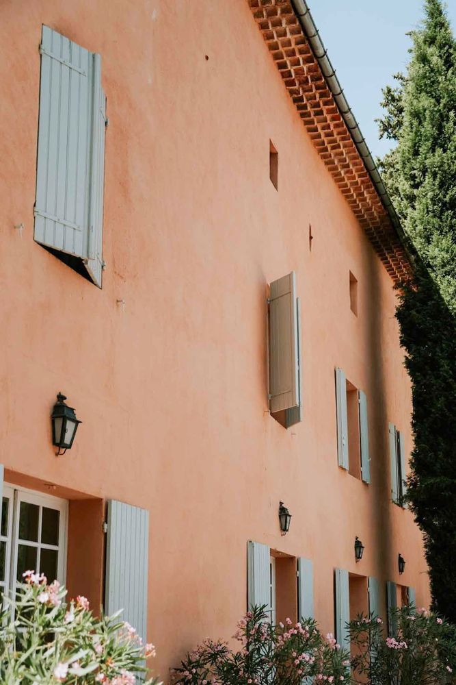The ochre wall and its blue-grey shutters