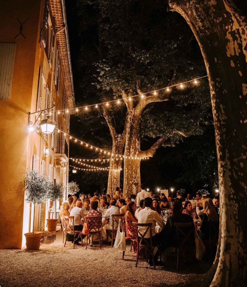The terrace at night, lit with string lights