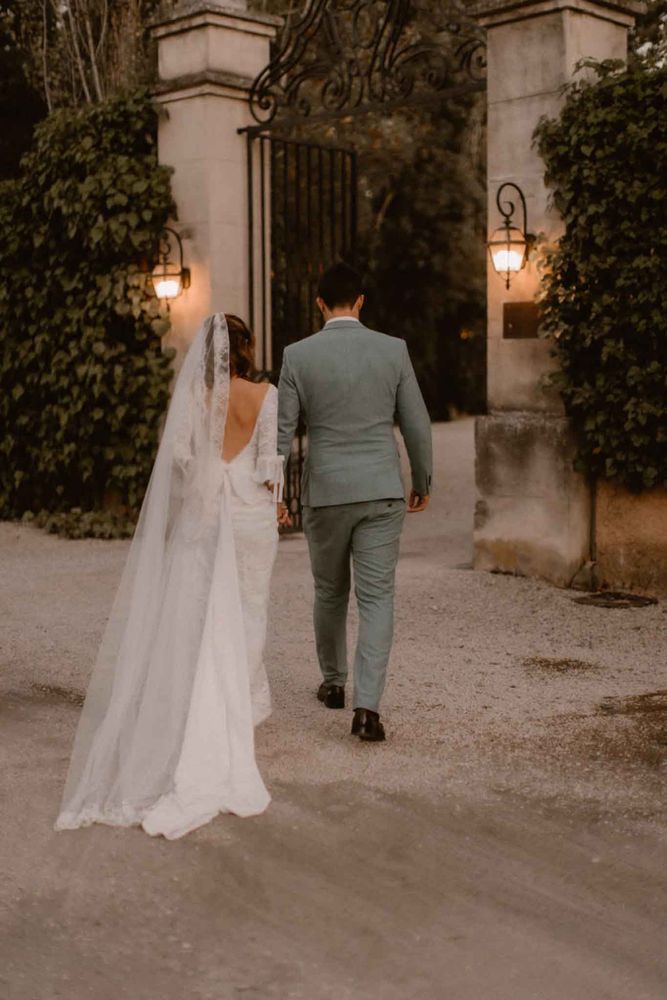 The newlyweds pass through the lit gate at night