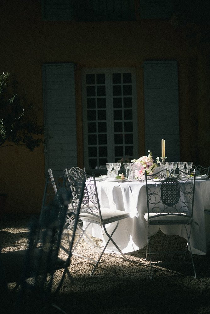A table laid in the shade of the façade