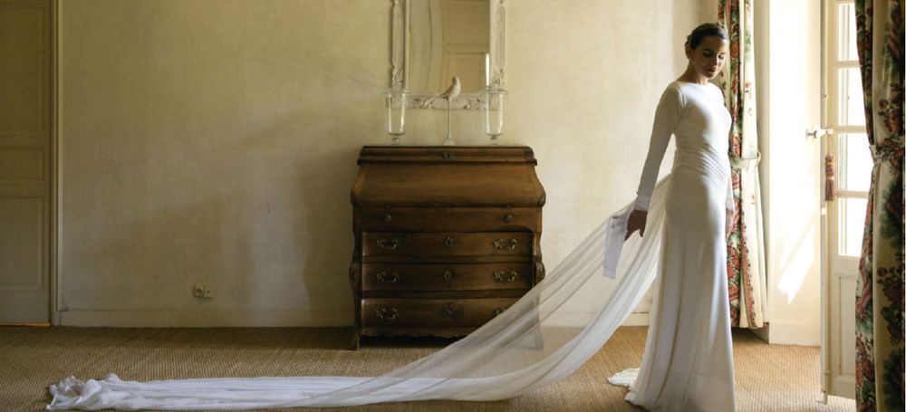 A bride and her long train in a suite
